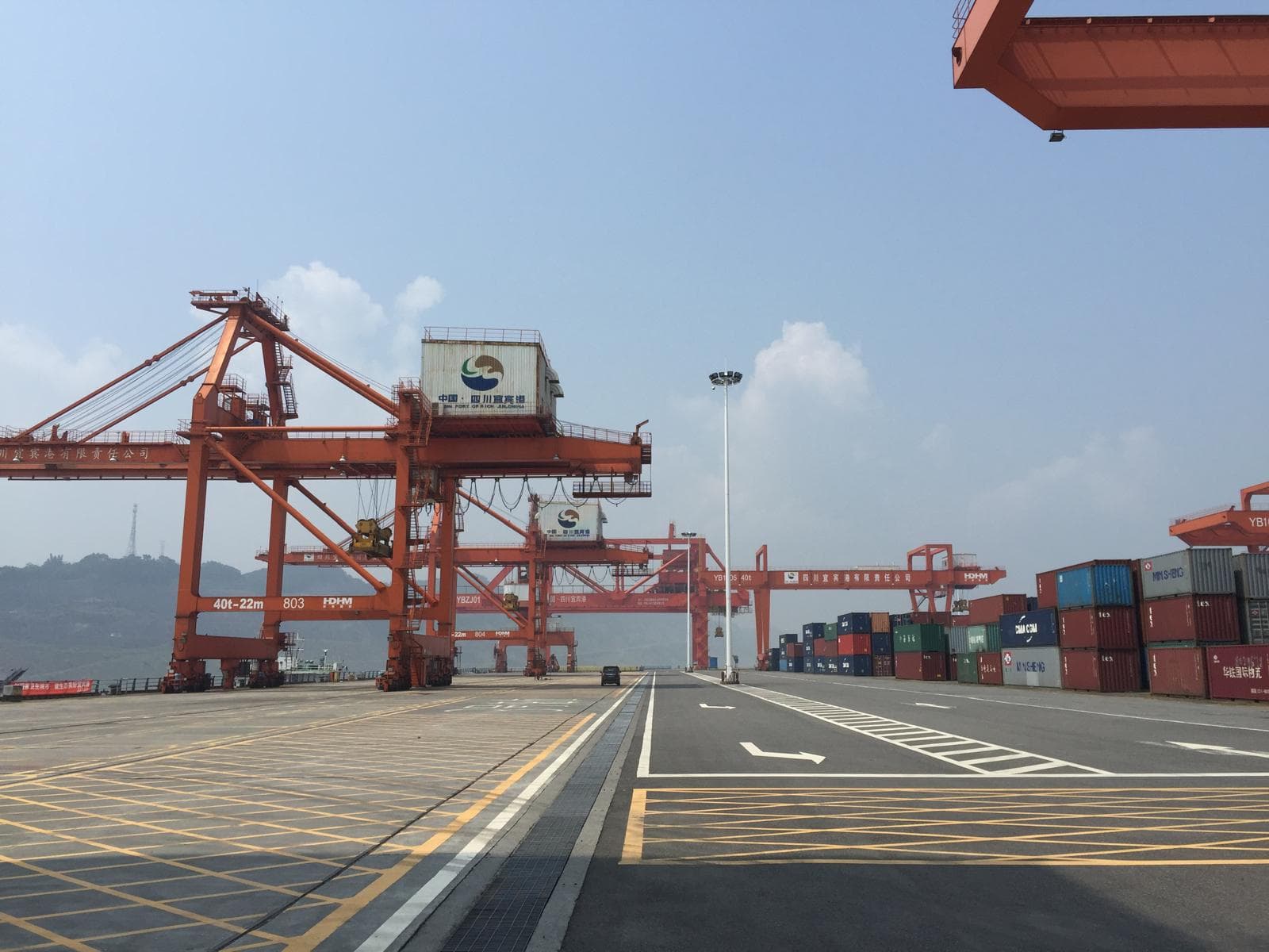 Container port with gantry cranes and stacked containers, for illustration